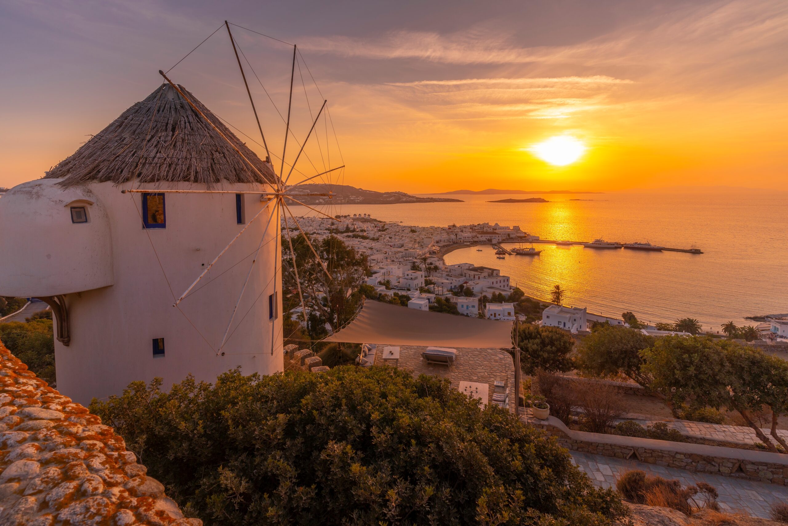 View,Of,Windmill,Overlooking,Town,At,Golden,Sunset,,Mykonos,Town,